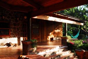 a porch with a dog laying on the patio at Casa Nora Malinalco - Entire Estate With pool in Malinalco