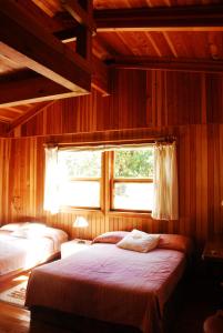 a bedroom with two beds and a window at Casa Nora Malinalco - Entire Estate With pool in Malinalco