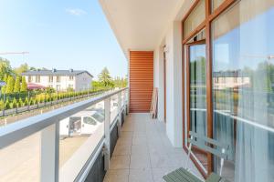 a balcony with a view of a house at Apartament Gaya23 Ku Morzu in Sianozety