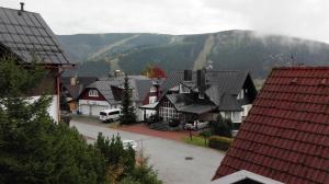 a group of houses with mountains in the background at Pension Karin in Špindlerův Mlýn