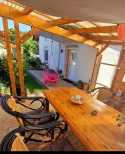 a wooden table and chairs on a patio at Ferienwohnung Sunny in Mittenwalde