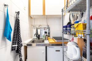 a small kitchen with white cabinets and a sink at GuestReady - Stylish Hideaway near Bercy Parc in Paris