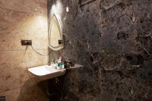 a bathroom with a sink and a mirror at Reunion Marina Villa in Udupi +34 photos