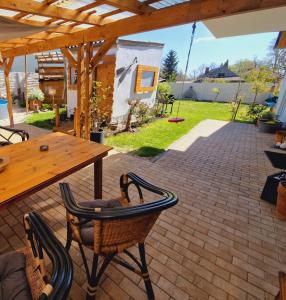 an outdoor patio with a wooden table and chairs at Ferienwohnung Sunny in Mittenwalde