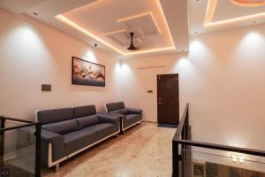 a living room with a couch in a room at Reunion Marina Villa in Udupi