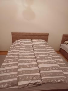 a bed in a room with a bedspread on it at Apartman Čerkez in Stolac