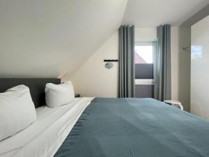 Postel nebo postele na pokoji v ubytování Am Kutterhafen 26 - Nordsee-Loft