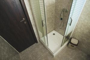 a shower with a glass door in a bathroom at Casa Cu Nuc in Brebeni +31 photos