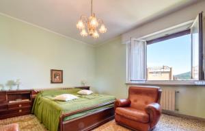 a bedroom with a bed and a chair and a window at Gorgeous Apartment In Sestri Levante in Sestri Levante