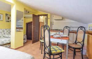 a kitchen and dining room with a table and chairs at Awesome Apartment In Trabia in Trabia
