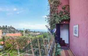 a pink building with a door and a view of the ocean at Awesome Apartment In Trabia in Trabia +11 photos
