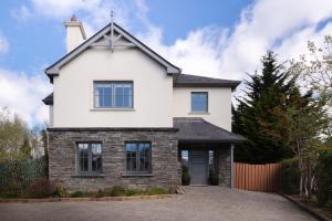 a white house with a turret at Luxury Interior Designed 4 Bedroom Villa, Kenmare in Kenmare