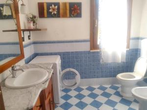 a bathroom with a sink and a toilet at 2 bedrooms apartement with lake view enclosed garden and wifi at San Mauro Pascoli 3 km away from the beach in San Mauro Pascoli