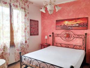 a bedroom with a bed and a pink wall at 2 bedrooms apartement with lake view enclosed garden and wifi at San Mauro Pascoli 3 km away from the beach in San Mauro Pascoli