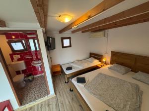 a small room with two beds and a mirror at Bazart Vama Veche in Vama Veche