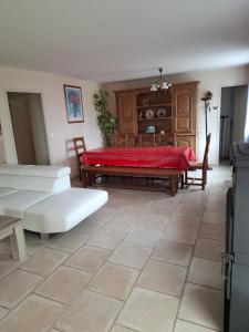 a living room with a couch and a table at campagne in Saint-Pardoux-le-Neuf
