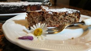 a piece of cake on a plate with a fork at Casa Due Tigli B&B in Corno di Rosazzo +26 photos