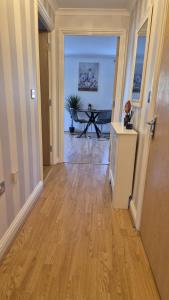a hallway with a room with a table and a table at Spacious 2 bedroom 2 Bathroom Flat in Hatfield near Hertfordshire University with Private Car Park Sleeps 5-6 in Hatfield