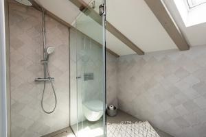 a bathroom with a shower with a toilet at Apartments Stone house in Tribunj +23 photos