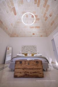 a bedroom with a bed with a wooden trunk on it at Volte D'Anima in Monopoli