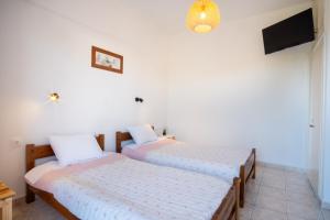 Postel nebo postele na pokoji v ubytování One House Pythagoreio