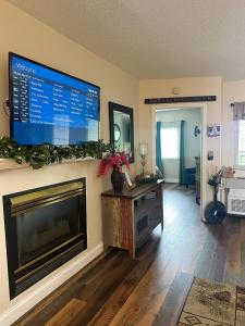 a living room with a flat screen tv above a fireplace at River Place Condos #206 2BD in Pigeon Forge
