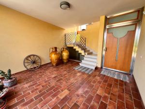 a room with two vases and a door and stairs at B&B La Rosa Blu in Bari