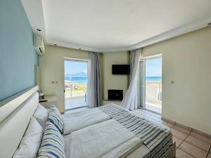 A bed or beds in a room at Blue Senses Hotel