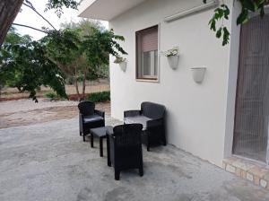 a group of chairs and a table in front of a building at Villa Angelica in Capilungo