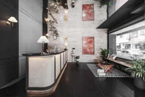 a lobby with a bar and a table and chairs at We2 Design Hotel in Taichung