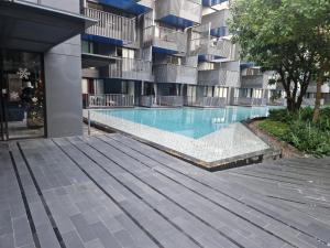 a swimming pool in front of a building at The Deck Condo Patong 5Fl Pool View in Patong Beach +13 photos