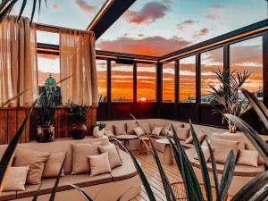 a living room with a sunset in the background at Prize by Radisson, Xhibition Bergen City in Bergen