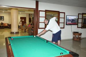 a man playing a game of pool on a pool table at Veronica Hotel in Paphos City