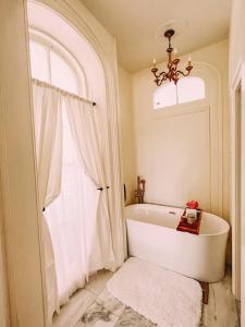 a white bath tub in a bathroom with a window at Mayhurst Estate in Orange
