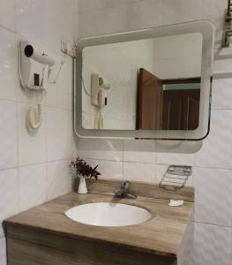 a bathroom with a sink and a mirror at Lotus by Serendib in Blantyre