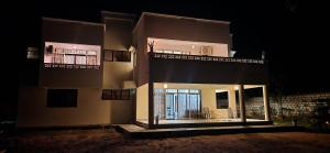 a large building at night with the lights on at Villa Salaam in Diani Beach