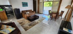 a living room with a couch and a table at Villa Salaam in Diani Beach
