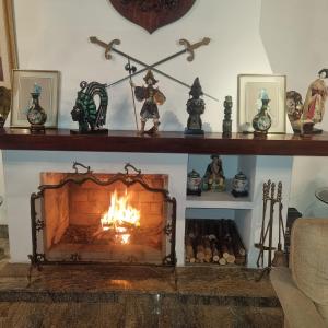 a fireplace in a living room with a fire at Pernambuco Club House in Guarujá