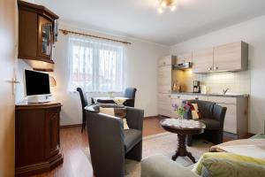 a living room with a couch and a table at Günther - Ferienwohnungen Zinnowitz in Zinnowitz