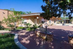a building with three benches in front of a building at Villa Galatea al mare - Tonnarella in Mazara del Vallo