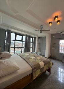 a bedroom with a bed and a ceiling fan at BAFFOUR APARTMENTS in Adiebaba
