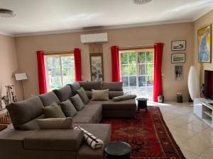 a living room with a couch and red curtains at Luxury holiday escape in the countryside tavira in Tavira