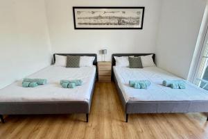 two beds sitting in a room at Luxury holiday escape in the countryside tavira in Tavira +29 photos