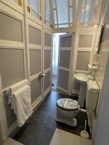 a bathroom with a toilet and a sink at Hotel De France in Perpignan