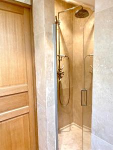 a shower with a glass door in a bathroom at Maison avec jardin - L'Orangerie in Thouaré-sur-Loire