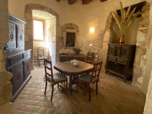 a dining room with a wooden table and chairs at Maison d hôtes du chateau de Bouesse in Bouesse