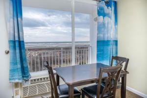 a dining room with a table and chairs and a window at Nassau Inn in Wildwood Crest