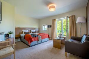 Postel nebo postele na pokoji v ubytování Montra Hotel Sabro Kro + 37 fotografií