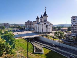 a large white church with a steeple in a city at Central Cosy Apart Oradea in Oradea