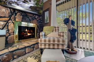 a living room with a stone wall with a fireplace at Bearadise Mountain Getaway by Eden Crest in Sevierville